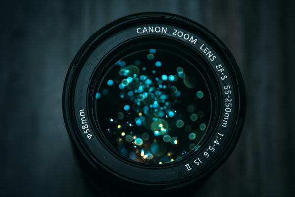 Camera lens with lights that look like bubbles reflected in the lens