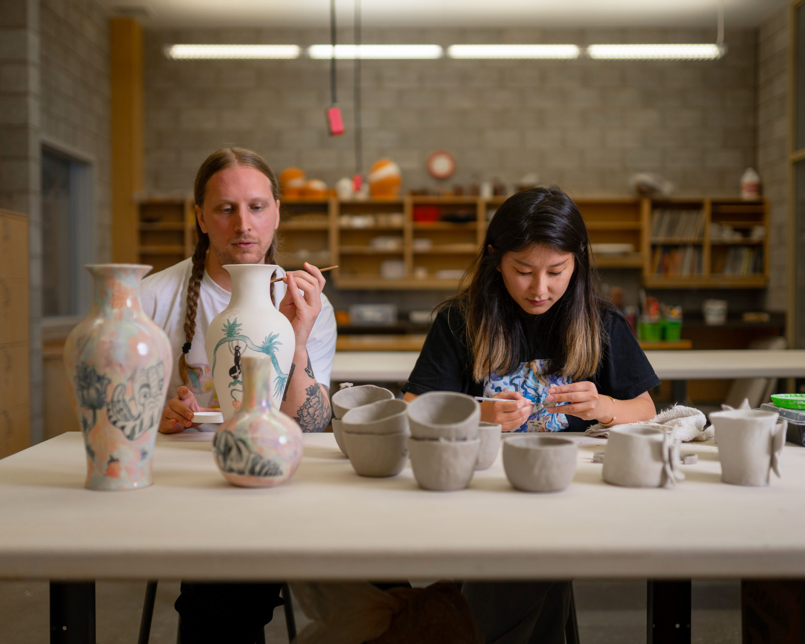 Two Artists working with ceramics in clay studio